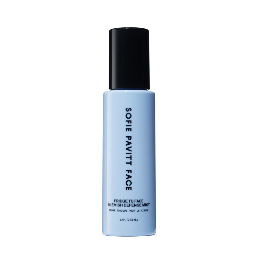 Blue bottle with black cap labeled 'Sofie Pavitt Face Fridge To Face Blemish Defense Mist' on a white background