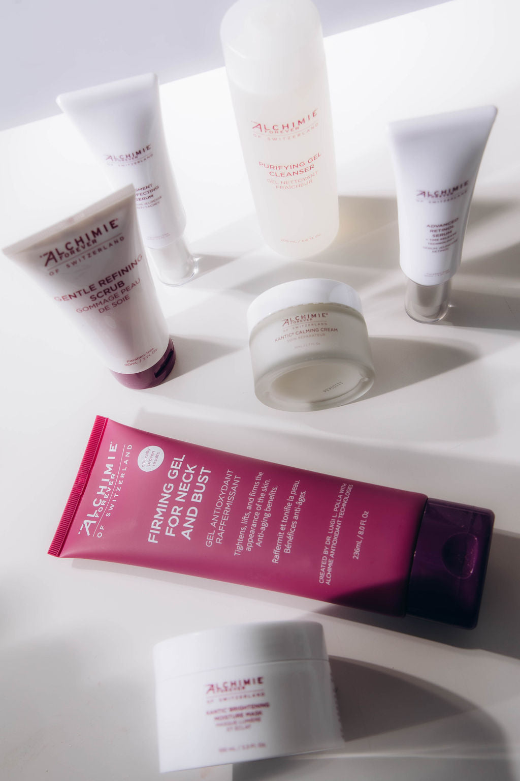 Collection of Alchimie Forever skincare products on a white surface