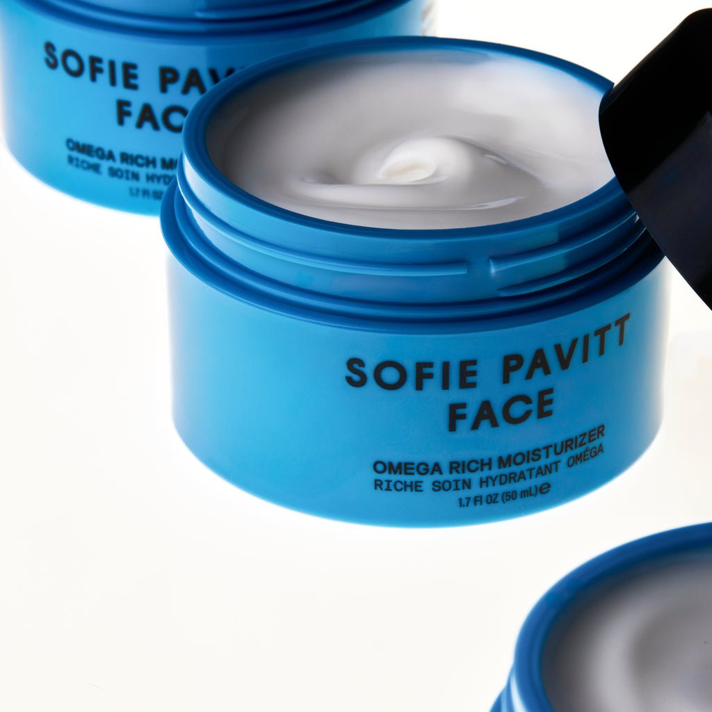 Blue jar of Sofie Pavitt Face moisturizer with a black cap on a white background